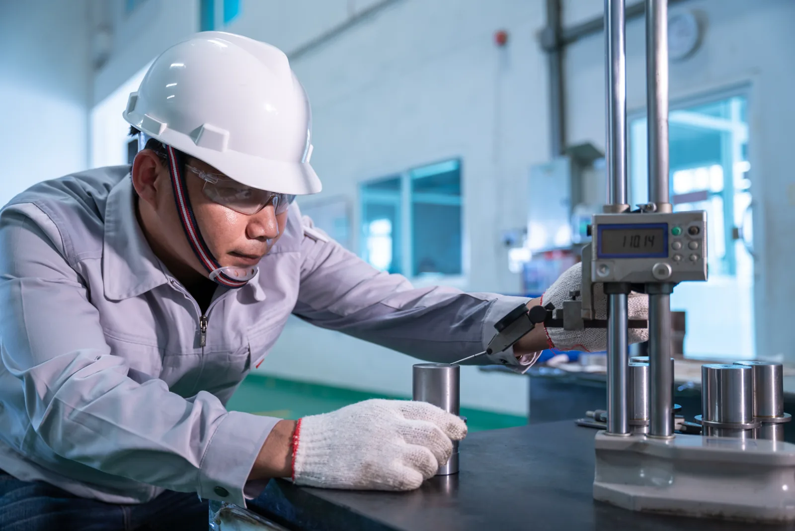 Technician checking a hydraulic machine in a factory